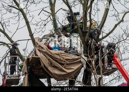 London, UK. 27th Jan, 2021. After negotiations with protesters in tree houses the bailifs begin to dismantle the first encampment- The anti HS2 Extinction Rebellion camp is cleared by Bailiffs at Euston Station. It is cleared by a company of enforcement officers called the National Enforcement Team, NET. Credit: Guy Bell/Alamy Live News Stock Photo