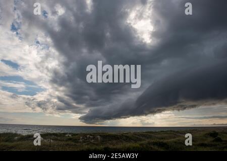 A shelf clouds appears on the leading edge of a storm in Atlantic Beach, North Carolina. Shelf clouds are a type of arcus cloud, which is a low, horiz Stock Photo