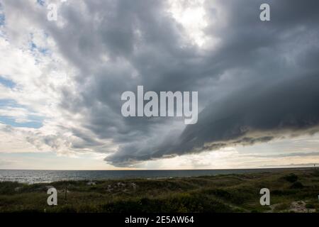 A shelf clouds appears on the leading edge of a storm in Atlantic Beach, North Carolina. Shelf clouds are a type of arcus cloud, which is a low, horiz Stock Photo