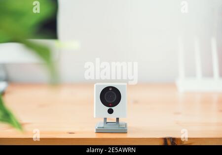 The CCTV security camera on Wood table in home, ip camera Stock Photo