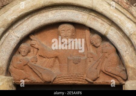 Jesus Christ surrounded with angels depicted in the Romanesque tympanum dated from the middle of the 12th century on the south facade of the Church of Saint James the Greater (Kostel svatého Jakuba Staršího) in the village of Jakub in Central Bohemia, Czech Republic. The Romanesque church consecrated in 1165 is considered to be one of the best preserved Romanesque monuments in the Czech Republic with the largest ensemble of Romanesque sculpture in the country. Stock Photo