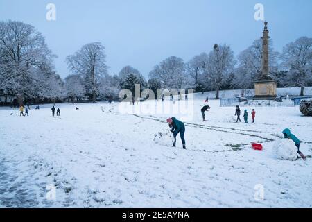 Families enjoying time in the snow at the Castle Green Hereford UK. January 2021 Stock Photo