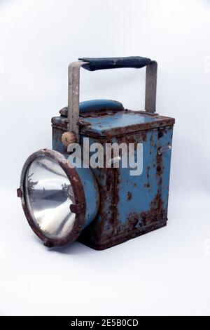 Old rusty blue railway lantern on white background. Stock Photo