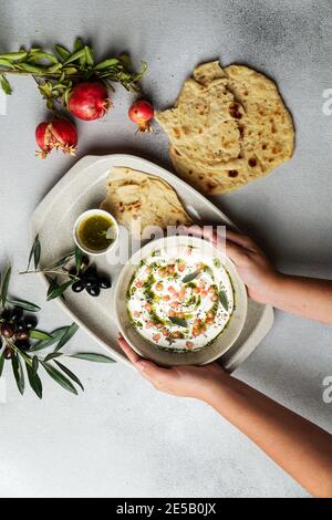 iranian or arabian dish, yogurt labneh goats milk dip with taftan bread and pomegranate Stock Photo