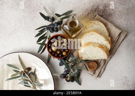 fresh black and green olives and olive oil on concret background. Top view with copy space for text Stock Photo