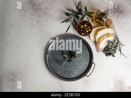 fresh black and green olives and olive oil on concret background. Top view with copy space for text Stock Photo