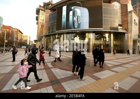 Beijing, China. 27th Jan, 2021. Chinese walk past an Apple showroom in a popular, international shopping mall in Beijing on Wednesday, January 27, 2021. Apple reported strong demand for the iPhone 12 in China, closing out 2020, with sales expected to be robust for the iPhone 12 family of devices throughout 2021. Photo by Stephen Shaver/UPI Credit: UPI/Alamy Live News Stock Photo