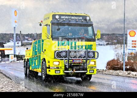 Volvo heavy duty recovery vehicle of Heavy Rescue Europe Oy, used for towing semi trucks leaving truck stop in snowfall. Salo, Finland. Jan 23, 2021 Stock Photo