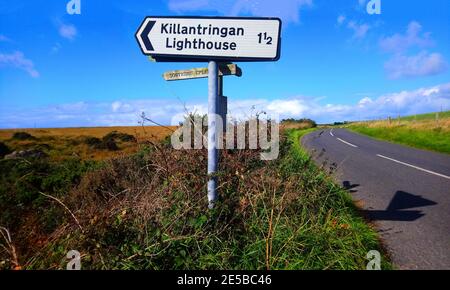 Killantringan Lighthouse and Southern Upland Way sign  (near Portpatrick, Dumfries & Galloway), Scotland in 2019 --  Killantringan is derived from 'Cill shaint Ringain' - St Ringan's chapel; Saint  Ringain or Ringain being a medieval referral to Saint Ninian. The Southern Upland Way runs from Portpatrick to Cockburnspath. It's traditionally walked from west to east, crossing the Southern Uplands from the Irish Sea to the North Sea, but this can be walked either way. Opened in 1984, the Southern Upland Way was the UK’s first officially recognised coast-to-coast long-distance footpath. Stock Photo