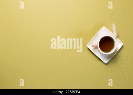 Cup of black tea on khaki green background. top view, copy space Stock Photo