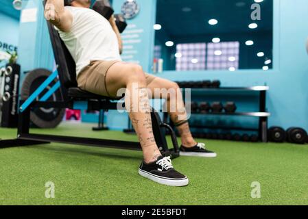 Strong man with tattoos prepares training in the gym to compete Stock Photo