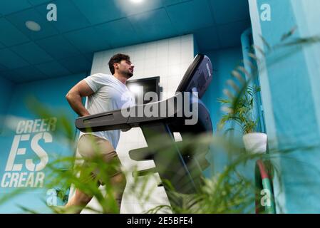 Strong man with tattoos prepares training in the gym to compete Stock Photo