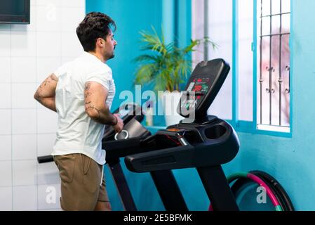Strong man with tattoos training in the gym to compete Stock Photo