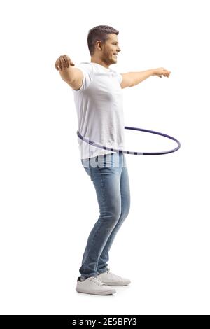 Young man in jeans and white t-shirt spinning a hula hoop isolated on white background Stock Photo
