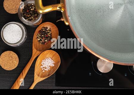 Copper pot with boiling water on a gas stove Stock Photo