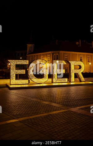 illuminated sign Egger in center of historic city, Northern Hungary Stock Photo