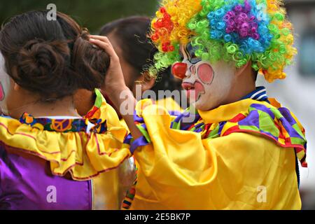 Young kids with colorful costumes participating at the parade of Día de los locos in San Miguel de Allende, Guanajuato Mexico. Stock Photo