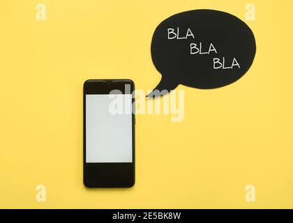 Smartphone with speech bubble on yellow background Stock Photo