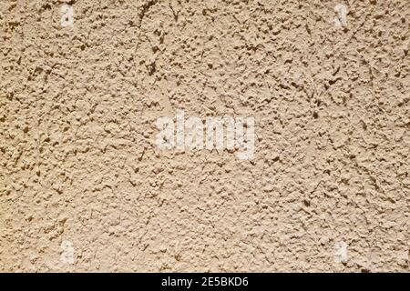 Texture of rough beige stucco wall. Decorative plaster on the wall. Stock Photo