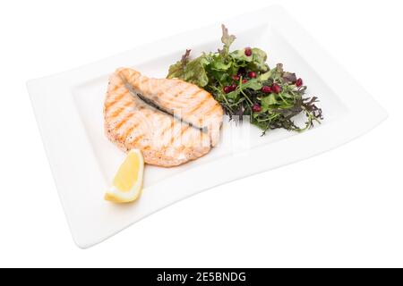 Steak of grilled salmon with vegetable salad. This is isolated in a white background. Close-up. Stock Photo