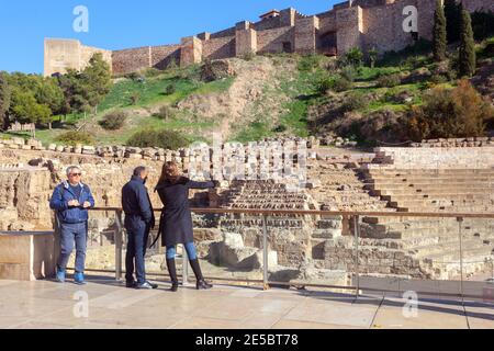 Ancient ruins of Roman theatre below Alcazaba fort in Malaga Costa del Sol Andalusia Spain tourists sightseeing Stock Photo