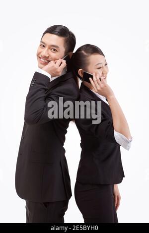 Young business man and woman back-to-back telephone high quality photo Stock Photo