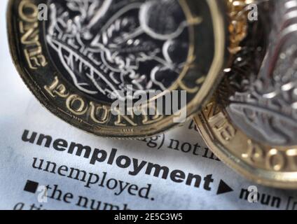 DICTIONARY DEFINITION OF WORD UNEMPLOYMENT WITH ONE POUND COINS RE COVID 19 CORONAVIRUS WORKERS UNEMPLOYED ETC UK Stock Photo