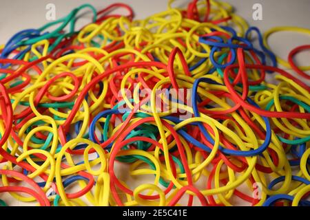 Multi-colored elastic band rubber scattered on the table. Stock Photo