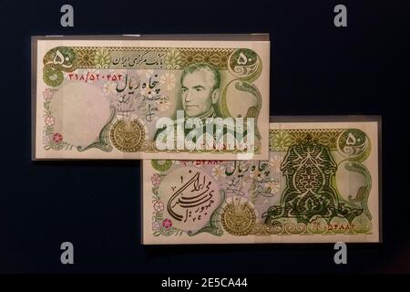 50 rial notes of Muhammad Reza Pahlavi, the Shah of Iran, (on bottom covered following revolution), the Money Gallery, Ashmolean Museum, Oxford, UK. Stock Photo