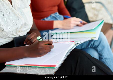 Close-up of two young women while they are studying. Multiethnic Stock Photo