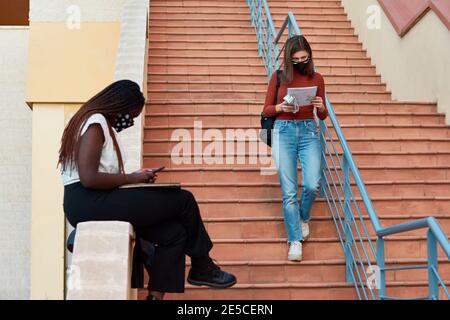 Two young students are on a university campus. Multiethnic concept Stock Photo