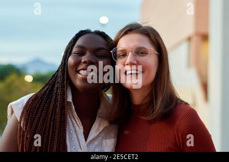 Two students are smiling and looking at camera. Multiethnic concept Stock Photo