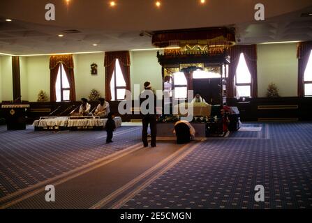 London England Sikh Funeral Granthi In Black Reading Sri Guru Granth Sahib Stock Photo