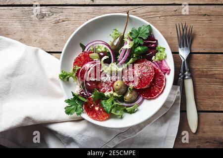Sicilian orange salad. Salad with blood orange, red onions and olives, top view. Stock Photo
