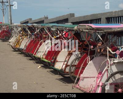 Ambon, Indonesia - Feb, 2018: Becaks, the traditional transportation in Indonesia. (Beca, Betjak, Betja, or Beetja). It is the Indonesian incarnation Stock Photo