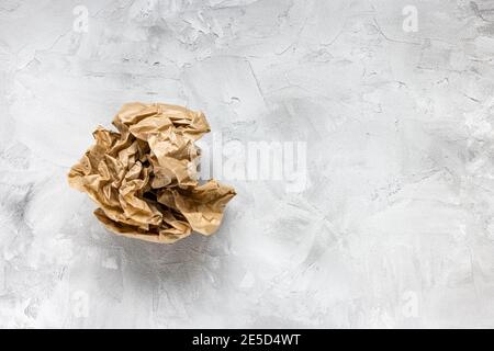Crumpled brown kraft paper on gray background Stock Photo