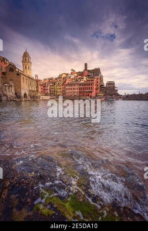 View across water to town, Vernazza, La Spezia, Liguria, Italy Stock Photo