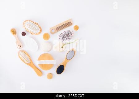 Zero waste kit for self body care in heart shape on white background. Eco friendly, plastic free bamboo brushes, soap, scrub, skin butter, comb Stock Photo