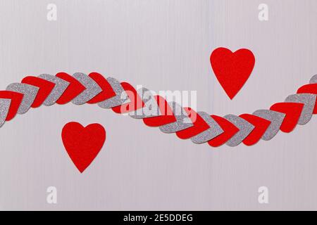 Two Red Hearts Apart With String Of Hearts On Textured White Stock Photo