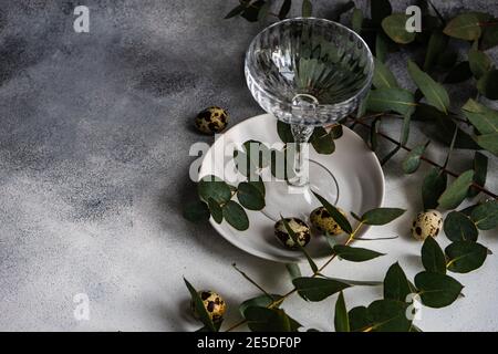 Easter table setting with Easter eggs and eucalyptus stems Stock Photo