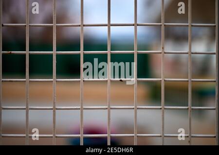 detail of deteriorated beige metal fence with a blurred background Stock Photo