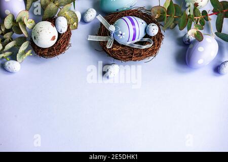 Easter eggs in bird's nests with eucalyptus stems Stock Photo