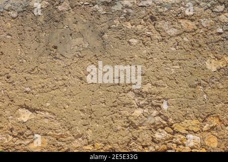 Old, rustic corroded and damaged stone and plaster wall. High quality texture and background for your projects and creative work Stock Photo