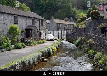 Waterside Cottages in Castleton in the Peak District national park Derbyshire England Houses by the village stream Stock Photo