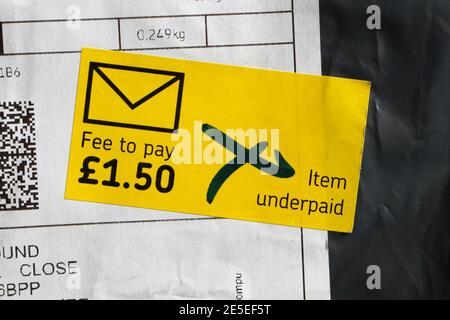 Royal Mail parcel letter, Fee to pay sticker, Item underpaid Stock Photo