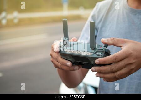 hands with remote controller of drone outside. Stock Photo