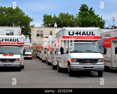 Rows of U-Haul trucks removal vans lined up in a Brooklyn New York depot parking lot moving house do-it-yourself DIY concept Stock Photo