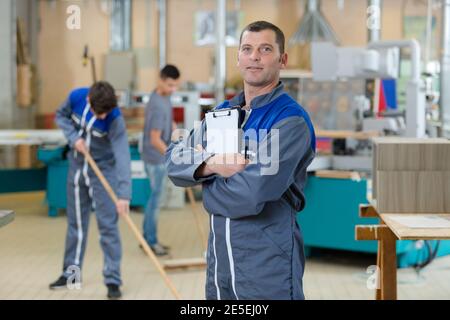 mechanic man holding a pen and a folder Stock Photo