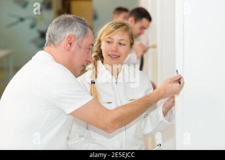 female apprentice decorator in training Stock Photo