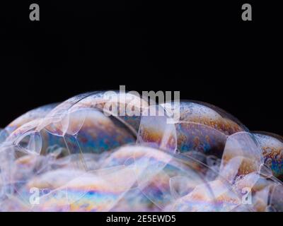 Macro shot of soap bubbles on black background. Close-up. Stock Photo